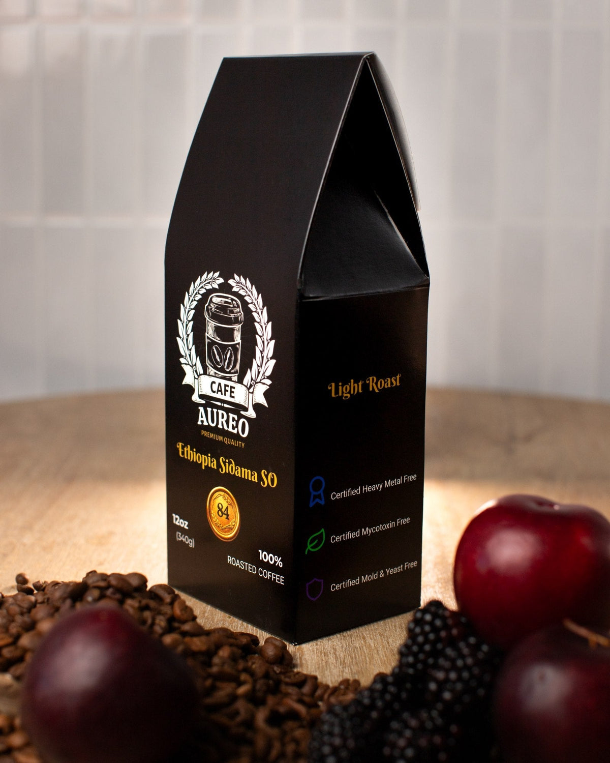 AUREO Ethiopia Sidama SO surrounded by dark red fruit and blackberries